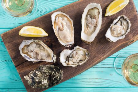 Fresh Oysters with lemon and white wine  . Seafood backgroundの写真素材
