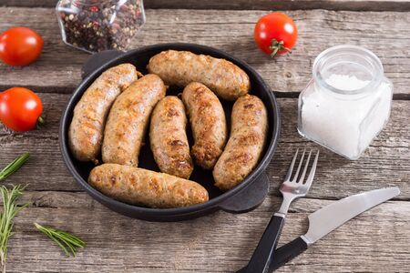 Grilled sausages with tomatoes , pepper and rosemary`. BBQ food backgroundの写真素材