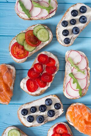 Variation of toast with fruit , vegetable and salmon . Healthy breakfast food backgroundの写真素材