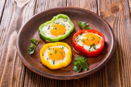Yellow , red and green pepper with fried eggs . Colorful healthy breakfastの写真素材