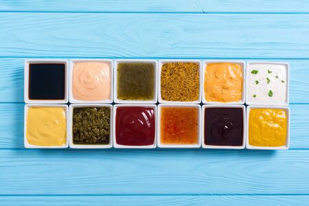 Set of different sauces in ceramic bowl on rustic backgroundの写真素材