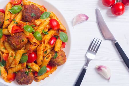 Italian penne pasta with meatballs and tomatoes . Food backgroundの写真素材