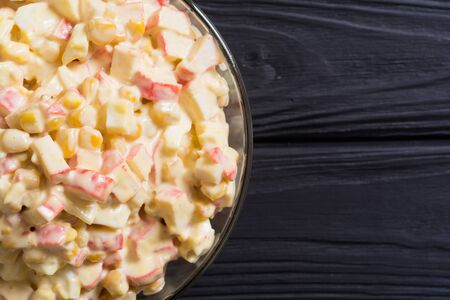 Traditional Russian New Year salad with crab sticks, corn, eggs and mayonnaiseの写真素材