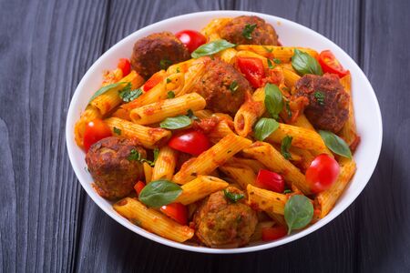 Italian penne pasta with meatballs and tomatoes . Food backgroundの写真素材