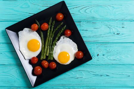 Healthy breakfast with eggs , asparagus and tomatoes . Vegetable backgroundの写真素材