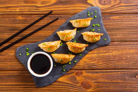 Traditional asian dumplings gyoza with green onion and soy sauce