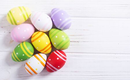Colorful easter eggs collection on wooden backgroundの写真素材