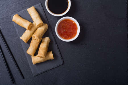 Asian food. Fried spring rolls with vegetables on rustic backgroundの写真素材