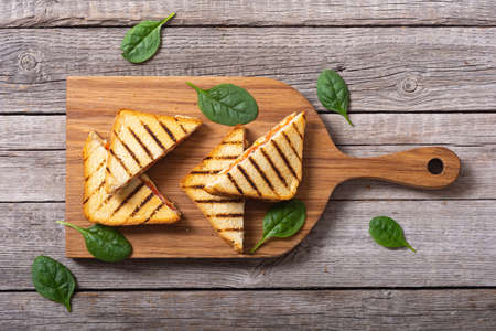 Grilled sandwiches with cheese. Fresh homemade breakfast on rustic backgroundの写真素材