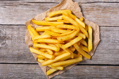 French fries with rosemary and ketchup. Fastfood background