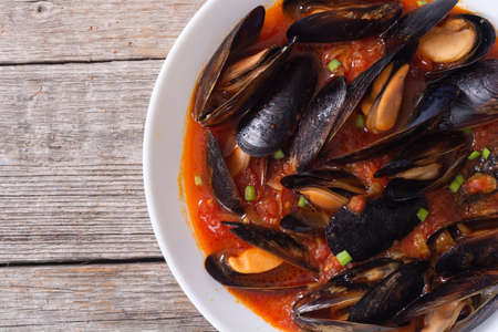 Traditional mussels tomato soup bouillabaisse. Seafood background.