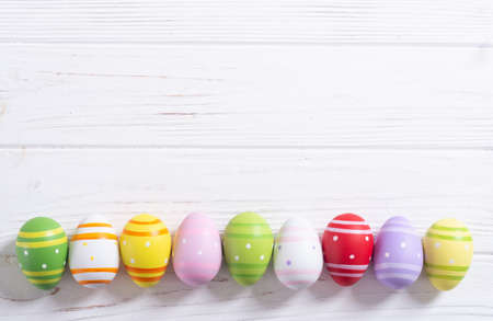 Colorful easter eggs collection on wooden backgroundの写真素材