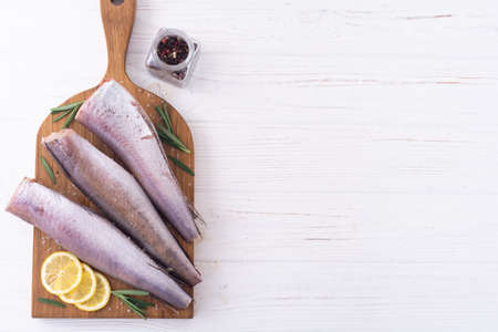 Raw hake on wooden background. ready to cooking