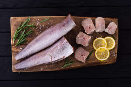 Raw hake on wooden background. ready to cooking