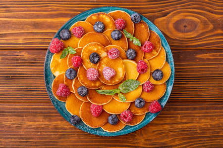 Mini pancakes with berries. Delicious breakfast. Food backgroundの写真素材