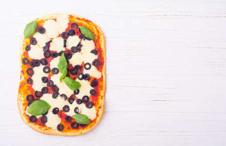 Traditional italian pizza with vegetables olives and basil. Pinsa romanaの写真素材