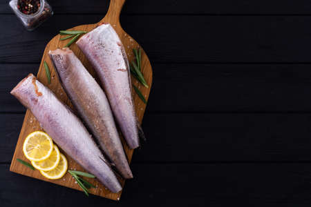 Raw hake on wooden background . ready to cookingの写真素材