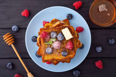 French toast with berries and honey . Sweet food background . Breakfast