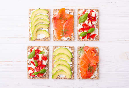 Crispbread with  salmon avocado mozzarella  and tomatoes . Healthy diet nutrion for vegan