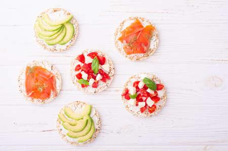 Rice cake with  salmon avocado mozzarella  and tomatoes . Healthy diet nutrion for vegan