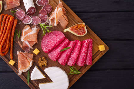 Board with meat, sausages and cheese. food background