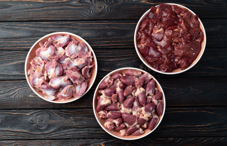 Raw chicken giblets raw poultry meat set: liver, stomach gizzard and heart. Top view