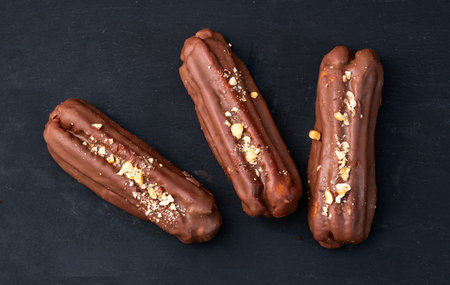 Classic French chocolate eclair. Food background top view