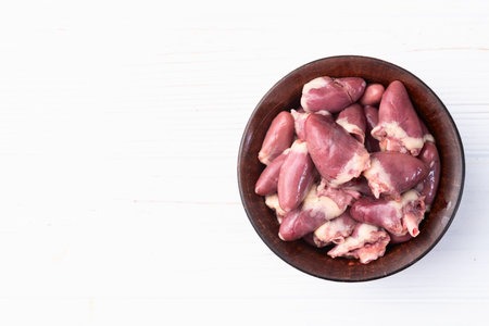 Raw chicken giblets hearts, meat background. Top viewの写真素材