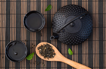 Green Tea with Japanese teapot and leaves. Top view