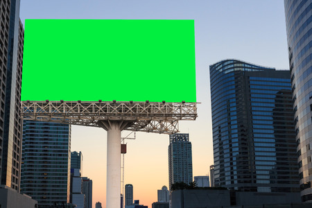 sign billboard blank on green isolated and urban landscapre backgroundの写真素材