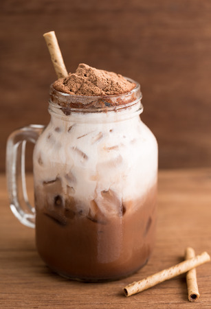 close-up malt chocolate beverage and milk in bottle on wood tableの写真素材
