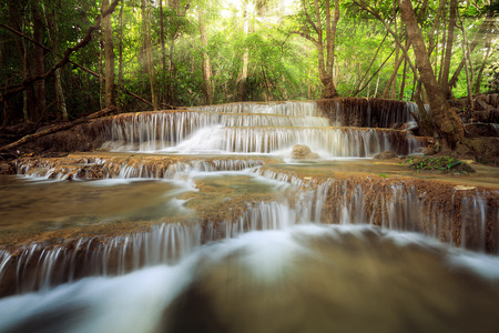 beauty sun ray over waterfall in nature, huay mae khamin national park thailandの写真素材