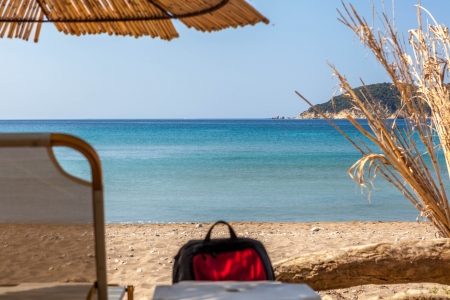 Beach umbrella and deck chairs on the beachの写真素材
