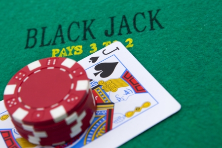black jack with red poker chips in the background.の写真素材