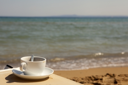 Cup of coffee at the beachの写真素材