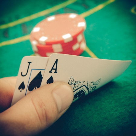 Vintage Ace of spades and black jack with red poker chips in the background.の写真素材