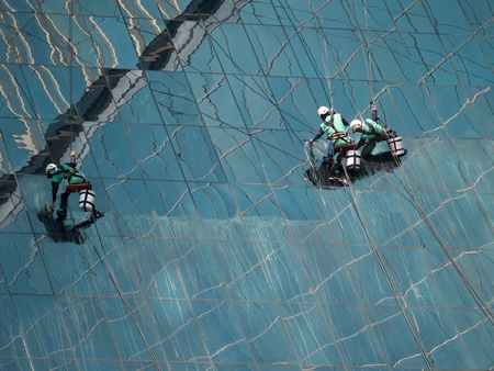 men cleaning glass buildingの写真素材