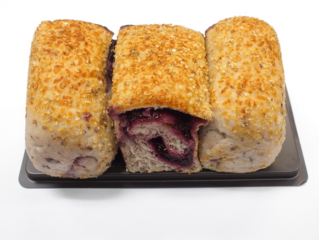 brown rice organic roll bread filled with dark cherryの写真素材