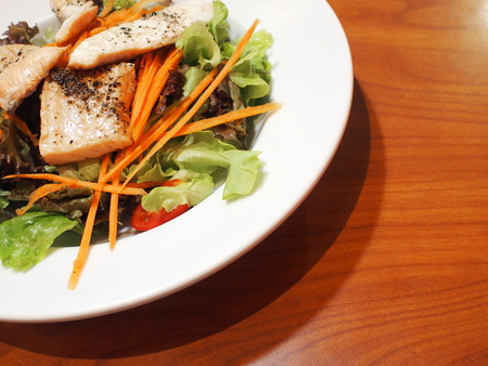 grilled salmon salad on wooden tableの写真素材