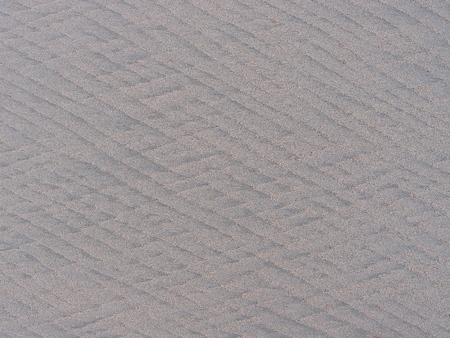 diamond texture made by sea wave on sandの写真素材