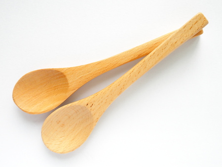 set of double beech wood tea spoon on white backgroundの写真素材