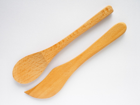 set of beech wood tea spoon and knife on white backgroundの写真素材