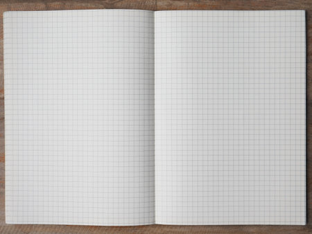 Blank notebook on a wooden background. Top view. Copy space.の写真素材