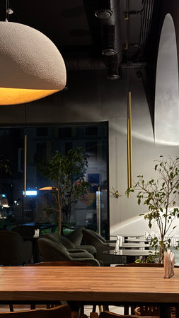 Interior of a modern cafe with wooden tables and chairs. Night viewの写真素材