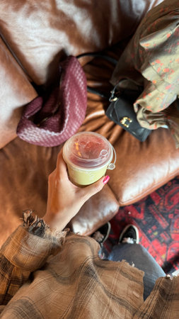 A woman is holding a cup of coffee in her hands. Close-up.の写真素材