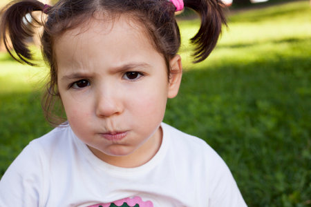 Bored three years old little girl. portrait outdoors