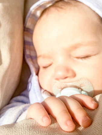 5 months baby sleeping placidly under the sun rays