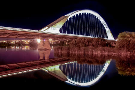 Lusitania bridge over Guadiana River at night, Merida, Spainの写真素材