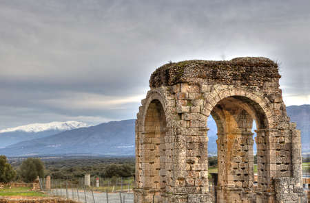 Roman Arch of Caparra with snowy mountains at bottom, Caceres, Spainの写真素材