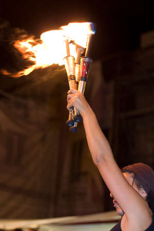 BADAJOZ, SPAIN - SEPTEMBER 26: Street performers holds lighted torches during the Almossasa Culture Festival on September 26, 2009 in Badajoz, Spainのeditorial素材